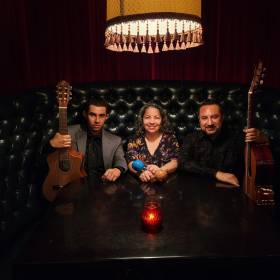Photo of Mauricio and his trio band in a booth