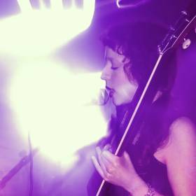 girl singing ino microphone with lens flare
