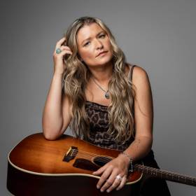 Sophie Gault sitting with Guitar